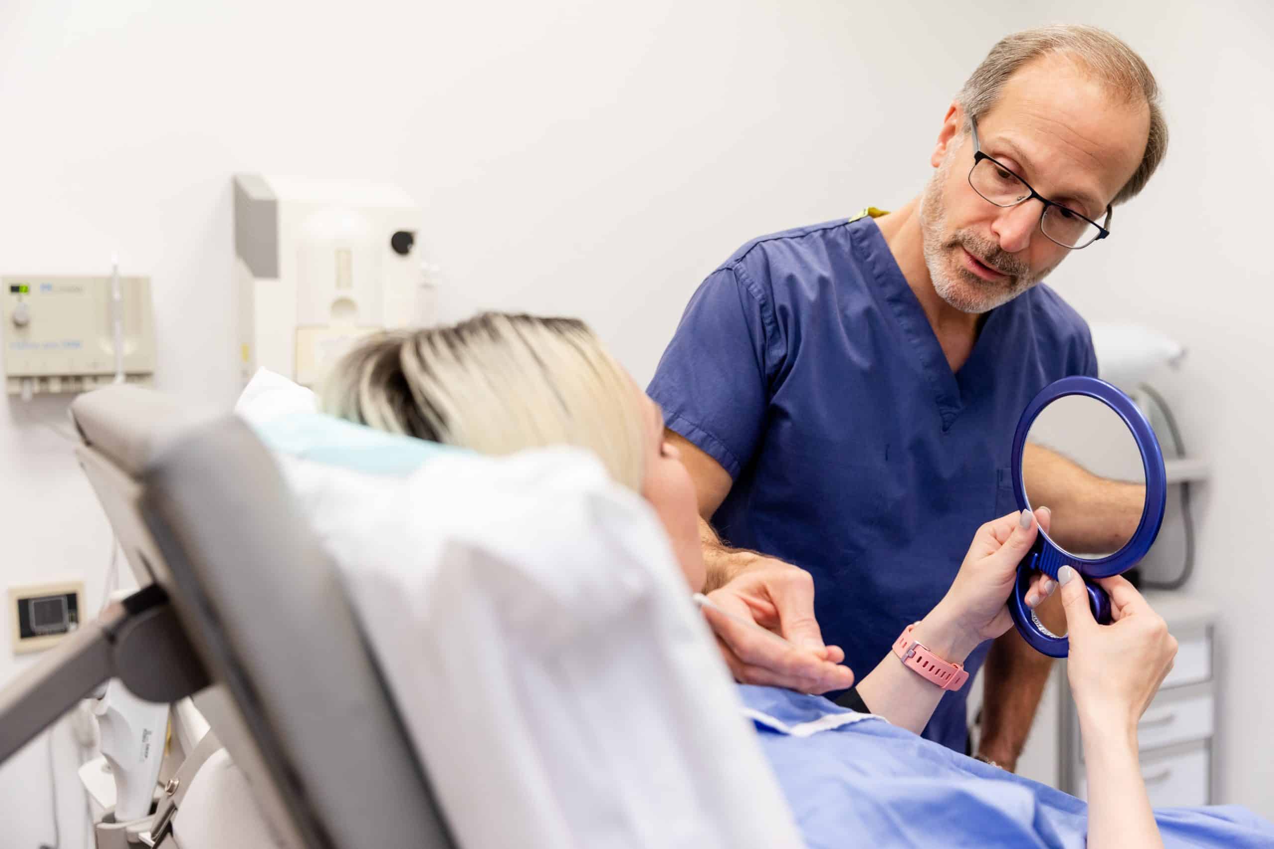 female patient reviewing results of clear+brilliant laser treatment