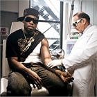 Rolling Stone Magazine photo of Dr. Geronemus removing 50 Cent’s tattoos