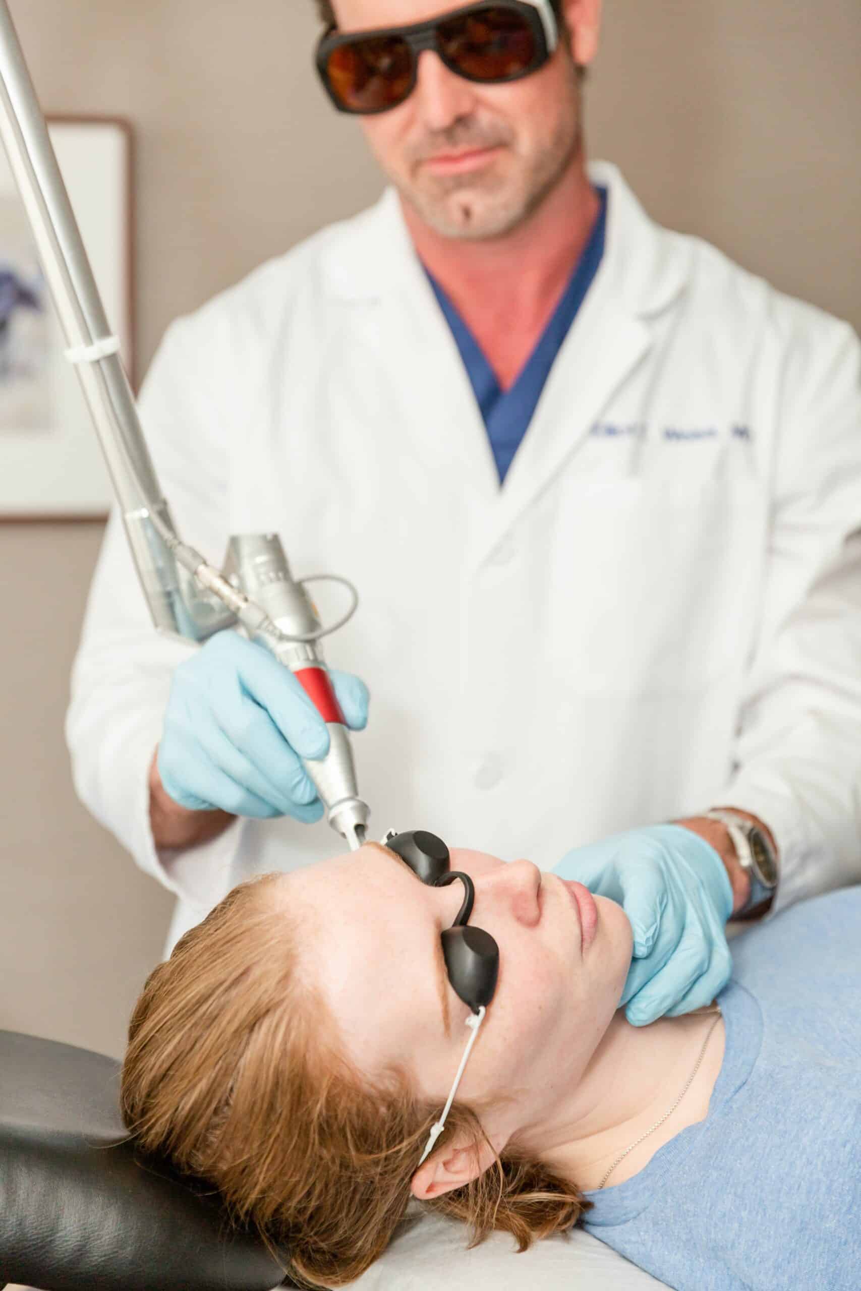 doctor performing laser freckle treatment