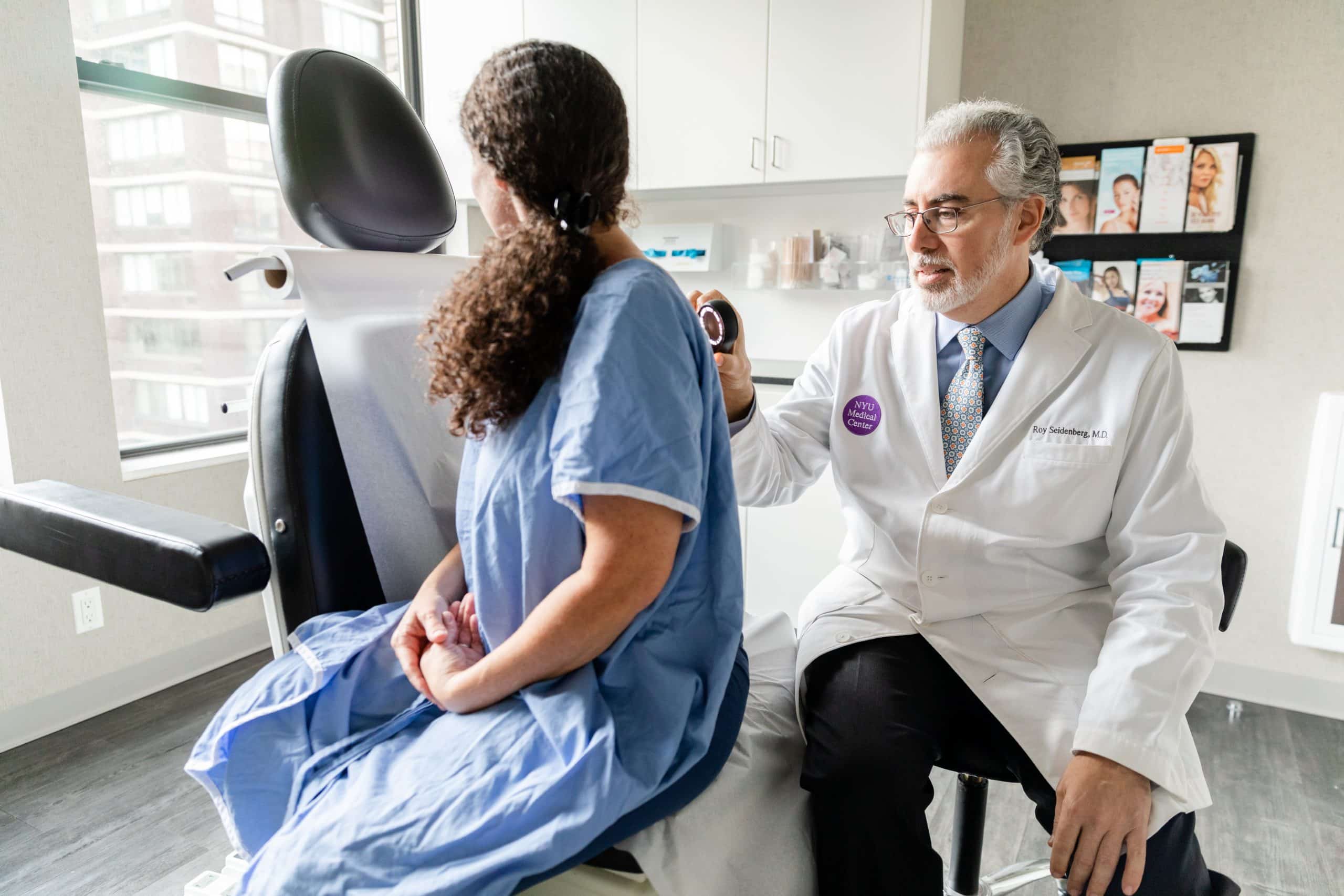 Psoriasis treatment, NYC Image showing doctor examining a female patient for psoriasis, NYC NY