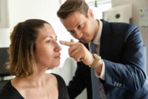 Plastic Surgeon Dr. Wilson is examining his patient's face at Laser & Skin Surgery in NYC, NY.